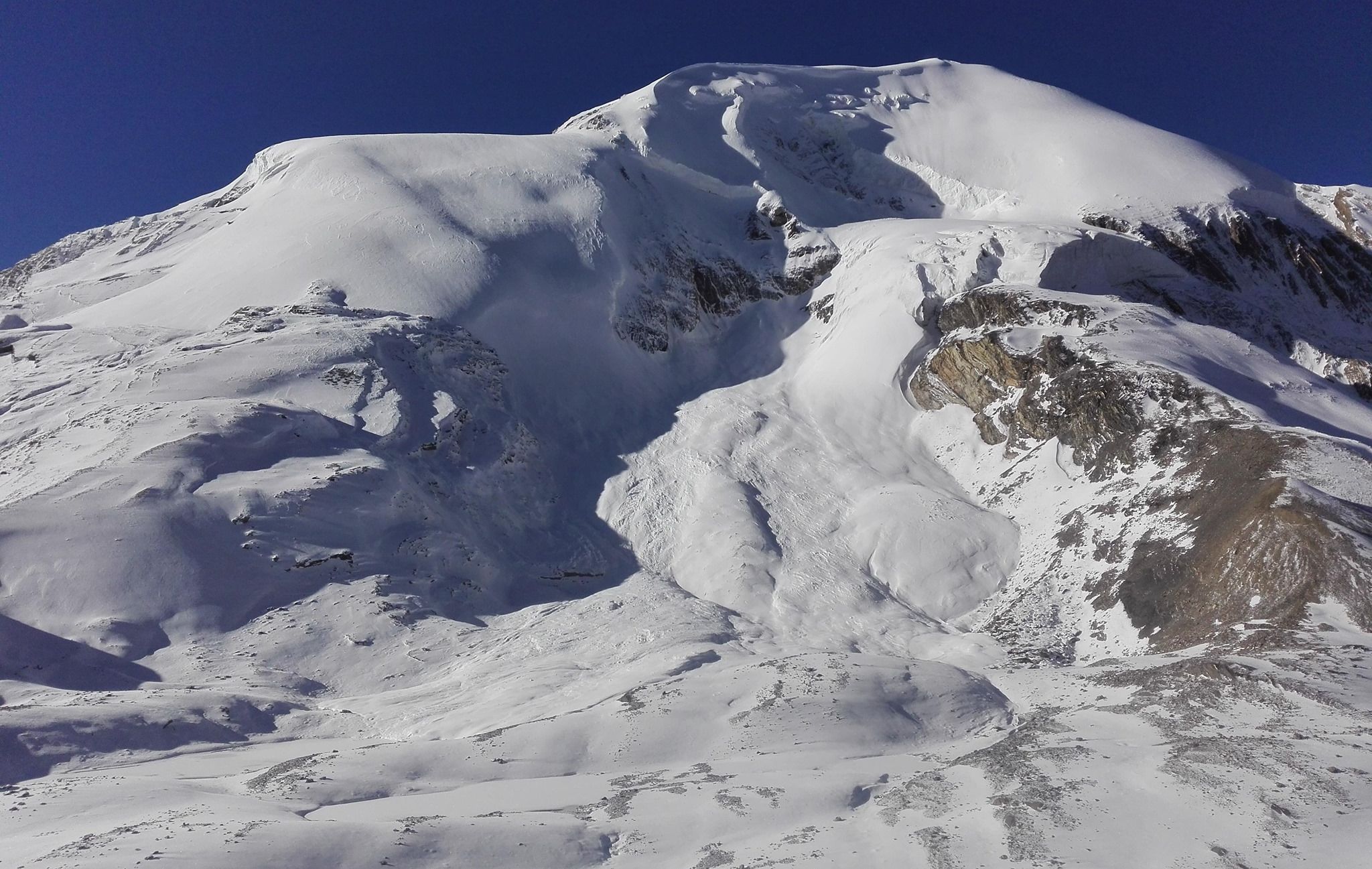 Tharong Peak ( Thorong Ri ) above Tharong La on crossing Tharong La high pass on Annapurna circuit trek in the Nepal Himalaya