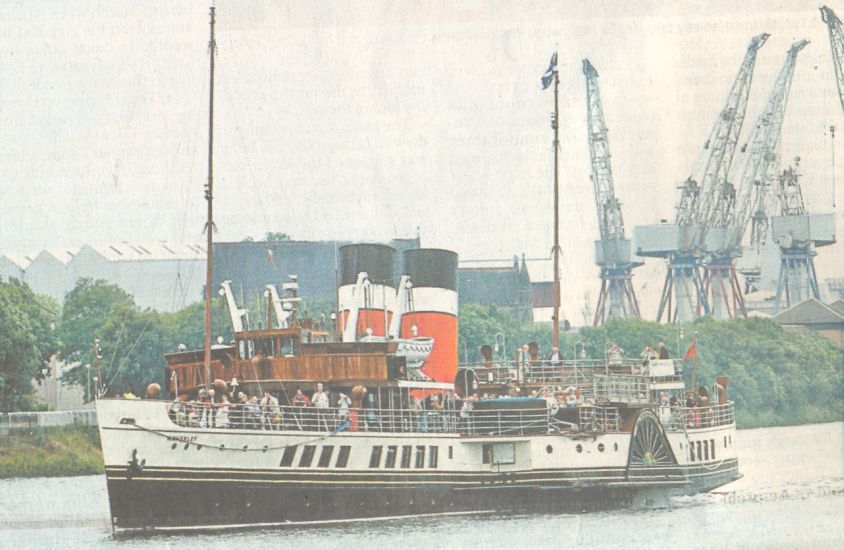 Waverley paddle boat passing shipyard cranes on the River Clyde in Glasgow