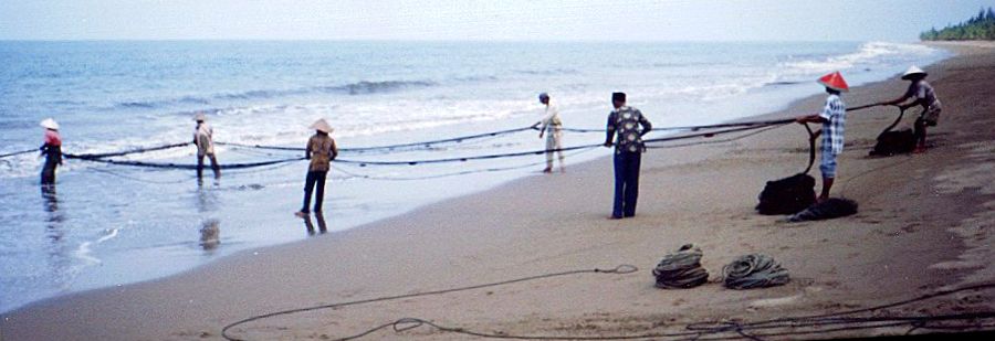 Fishermen and boat on beach near Padang on Sumatra