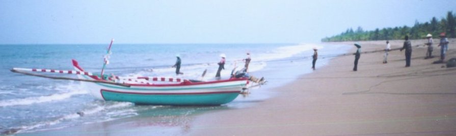 Fishermen and boat on beach near Padang on Sumatra